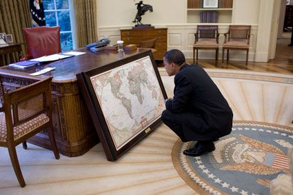 Obama with map in Oval Office
